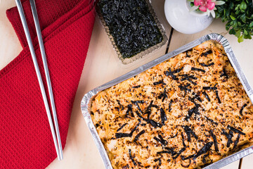 a tray of baked sushi, layered rice, egg, Japanese mayo and topped with meat or seafood    © recyap