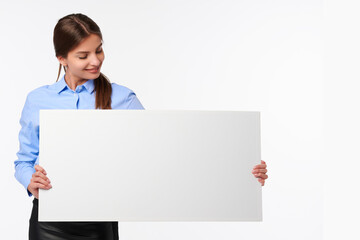 Attractive businesswoman in shirt holding white blank billboard and smiling on white isolated background