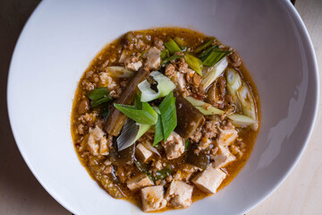 a bowl of hot spicy mapo tofu is a type of dish that uses ground pork, tofu and spicy fermented beans 