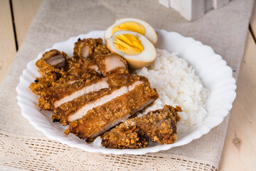 crispy fried pork that uses sweet potato flour with boiled egg and rice