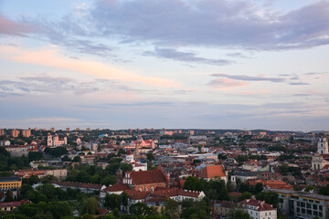 Fototapeta na wymiar Vilnius panorama shot at sunset. Framing with greenery.