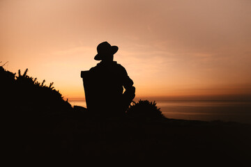 A man sitting watching the sunset