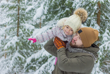 Obraz premium Father and daughter have fun in snowy forest in winter. Enjoy to spend time together.