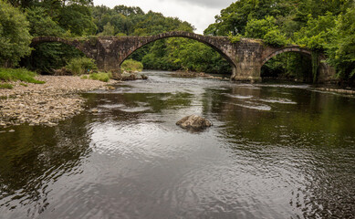 Cromwells bridge in the Ribble Valley, Lancashire. Old stone bridge over the river Hodder