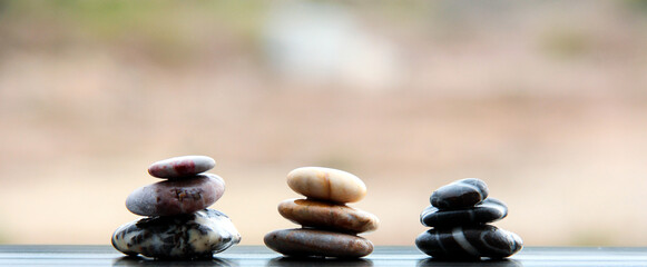 Sea stones. Pyramids of small stones. Sea background.