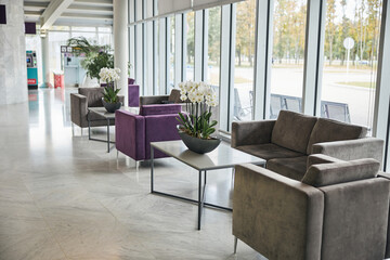 Fototapeta na wymiar Empty airport terminal waiting area with comfortable furniture