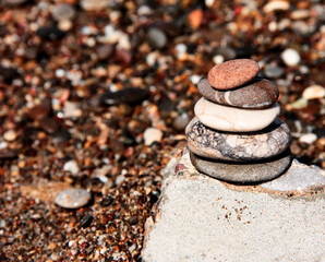 Pyramid of sea stones. Sea tour. Pebbles of the sea.