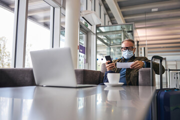 Businessperson with a cellphone sitting in the armchair