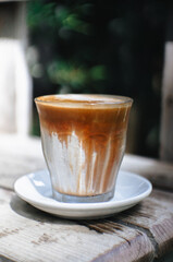 Dirty Coffee or milk coffee latte on a wooden table.