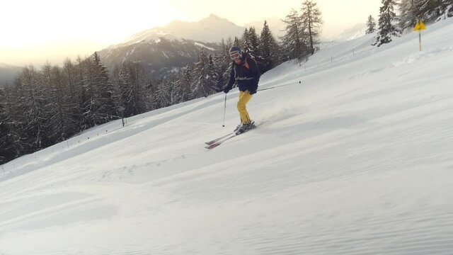 Downhill skiing. Camera tracking along fluently with skier. . High quality FullHD footage