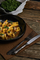 Italian ravioli stuffed with meat closeup on a black plate. rustic style