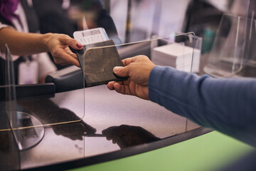 Man showing his passport at the check-in desk