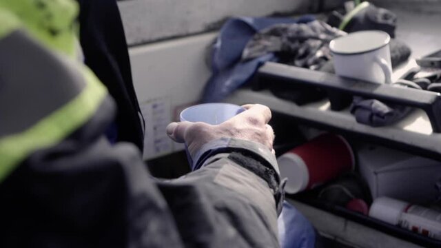 Sailer drinking his coffee inside a Swedish boat around Stockholm archipelago, 24fps.