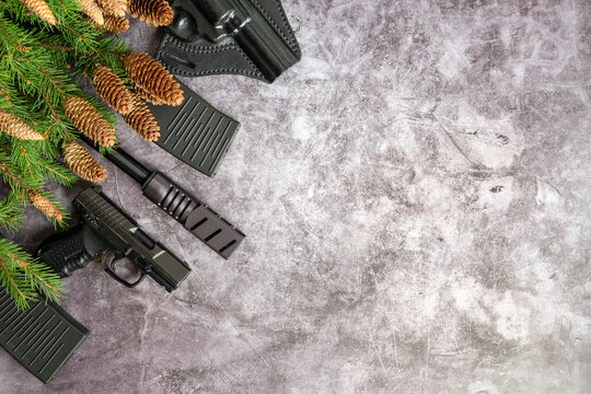 Gun, Headphones, Cartridge Machine Gun On A Gray Concrete Background. Christmas Concept.