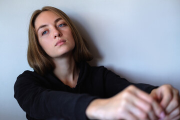 Fototapeta premium young beautiful sad and desperate caucasian woman suffering depression looking thoughtful and frustrated at somewhere, looking depressed at the room. Depressed young girl sitting on floor at home