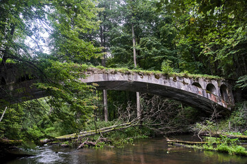Fototapeta na wymiar Old German bridge. The bridge of the Rominten Forest. Vishtynetskoe lake. Kaliningrad region. 