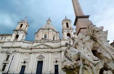 Fototapeta na wymiar Piazza Navona is a symbol of Baroque Rome, with Bernini's Fontana dei Quattro Fiumi and Borromini's church of Sant'Agnese in Agone.