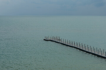 Fototapeta premium The buoy walkway extends into the sea.