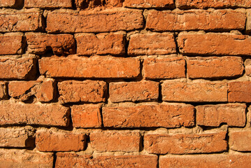 Old weathered grunge brick masonry wall closup as brick background