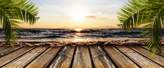 empty wooden table on the background of the seascape at sunset, panoramic image