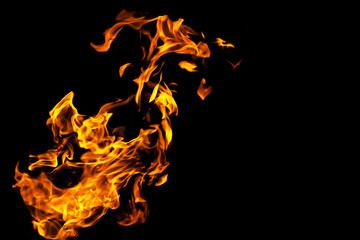 Obraz premium Fire flames on black background isolated. Burning gas or gasoline burns with fire and flames. Flaming burning sparks close-up, fire patterns. Infernal glow of fire in the dark with copy-space