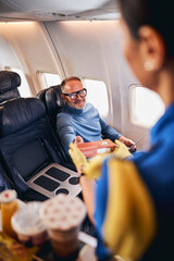 Smiling pleased man receiving the airline food