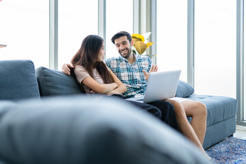 Couple man and woman talking with happy expression in the living room. Lifestyle couple in domestic area.