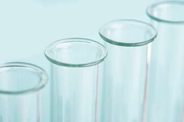 Macro laboratory glass test tubes over blue background