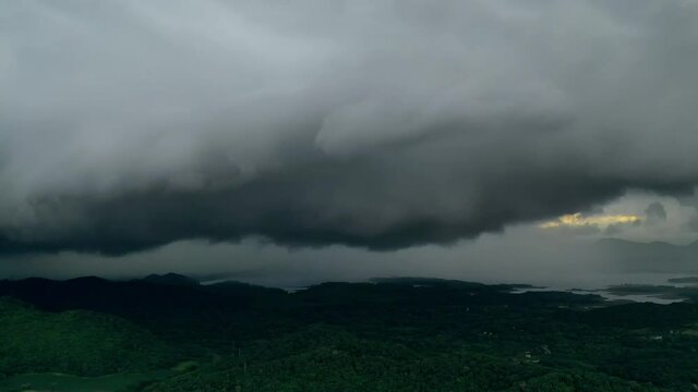 Hyper lapse video 4K, Arcus cloud or shelf cloud, Rain storms and black clouds moving over the mountains in dam the north of Thailand, Mae Mo district, Lampang.