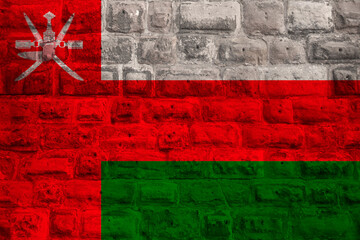 national flag of the modern state of Oman on an old historical stone wall, concept of business,...