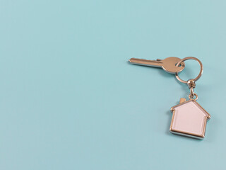 silver house - keychain and key on a blue background