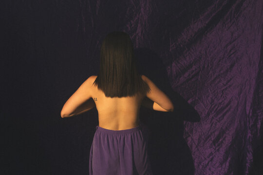 Woman Wearing Purple Pants And No Top