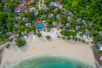 Fototapeta na wymiar Tropical beach with turquoise ocean in paradise island. Aerial view. Paradise resort.
