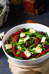 Spicy green bean salad with olives, feta cheese and dried tomatoes
