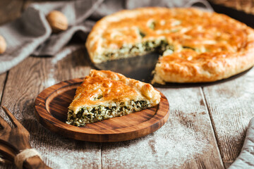Cut pie with spinach and cheese filling