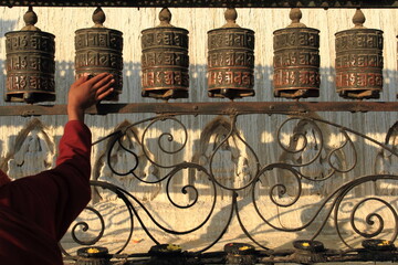 A Buddhist Monk (not visible in picture) spin a prayer wheel in Swoyambhunath Temple, Nepal.