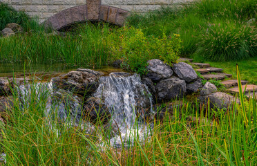 Small waterfall. The water flows beautifully over the stones. Hiking. Landscape.
