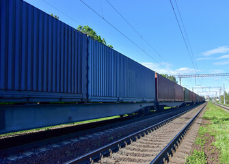 Cargo Containers Transportation On Freight Train By Railway. Intermodal Container On Train Car....