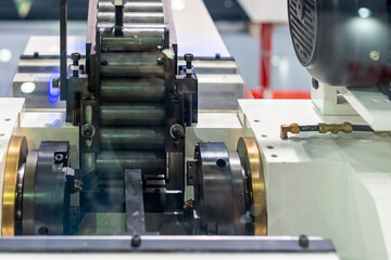 Cylindrical steel workpiece or pipe It is arranged in a automatic conveyor rail sent to a lathe machine for forming in production line at factory