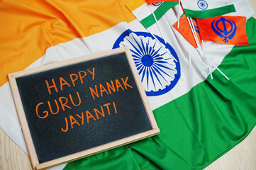 Happy Guru Nanak Jayanti theme. Board with flags.