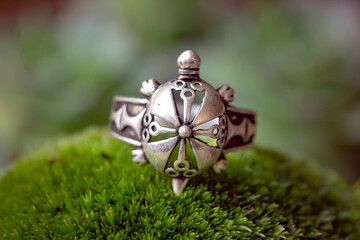 Sterling silver ring in the shape of turtle on green moss background