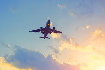 Travel by plane in a beautiful sky at sunset with clouds.