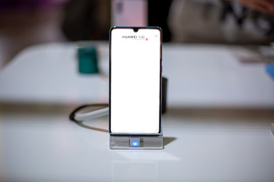   Moscow, Russia - October 04, 2019: Huawei P30 Pro smartphone on phone stand. front view, close up, soft focus. backround in blur