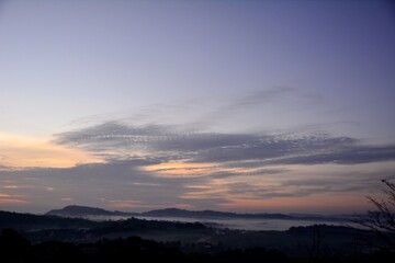 Beautiful Landscape of mountain layer in morning sun ray and winter fog