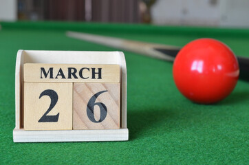 March 26, number cube with balls on snooker table, sport background.