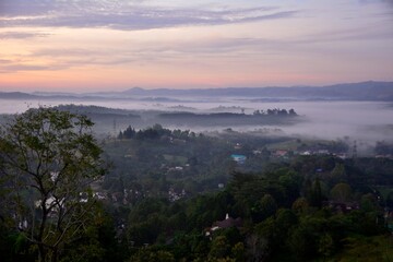 Beautiful Landscape of mountain layer in morning sun ray and winter fog