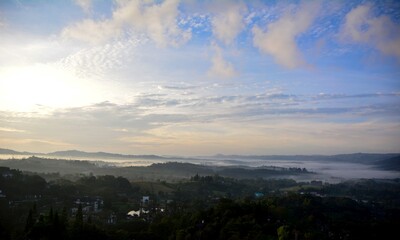 Beautiful Landscape of mountain layer in morning sun ray and winter fog