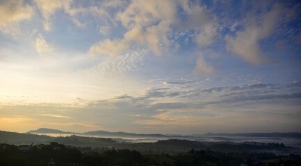 Beautiful Landscape of mountain layer in morning sun ray and winter fog