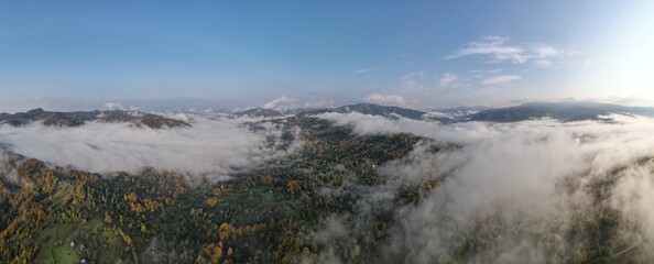 Panoramic landscape above mountains with sun rising.