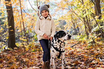girl with dalmatians dog on autumn season